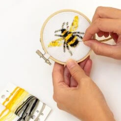 KIKKERLAND Mini Cross Stitch Embroidery Kit - Bee -Kikkerland bee mini cross stitch embroidery kit in use