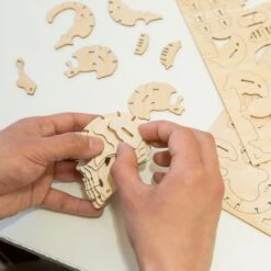 KIKKERLAND Skull 3D Wooden Puzzle -Kikkerland skull 3d wooden puzzle being assembled