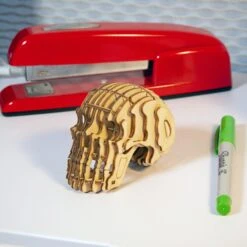 KIKKERLAND Skull 3D Wooden Puzzle -Kikkerland skull 3d wooden puzzle on table